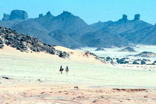Two riders on camels approach